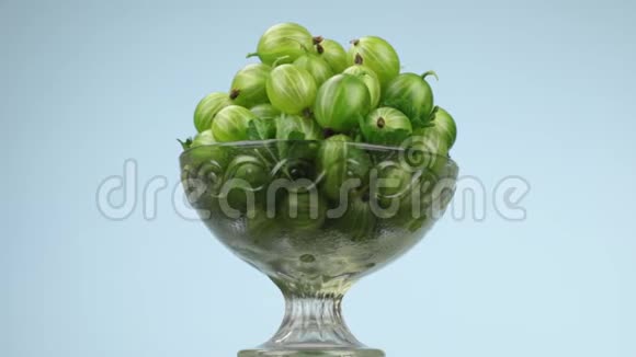旋转玻璃花瓶与一堆成熟多汁的绿色醋栗视频的预览图