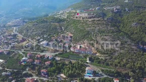 飞越位于地中海边的土耳其的阳光镇阿拉尼亚艺术覆盖山坡的鸟瞰图视频的预览图