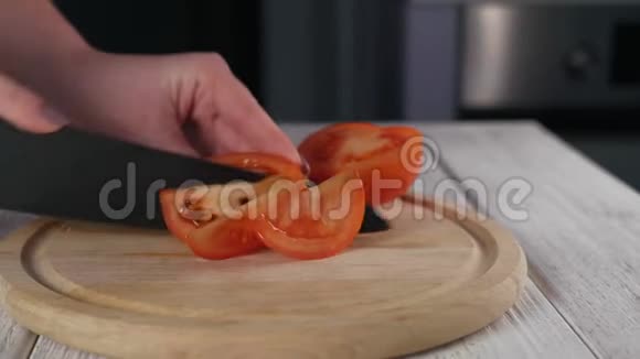 女士用厨房刀切熟番茄视频的预览图