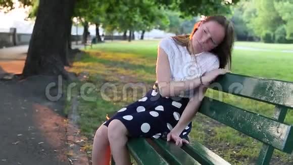 年轻女孩坐在公园的长凳上心烦意乱青少年的问题视频的预览图