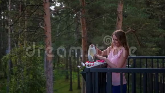 女人在乡间别墅的阳台上浇花视频的预览图