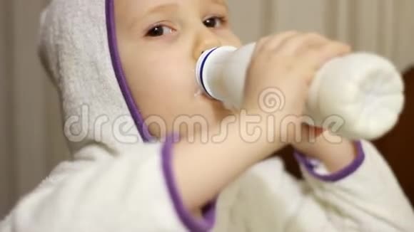 小女孩喝着一瓶牛奶饮料凯菲尔微笑着从酸奶中露出一个白色的胡子视频的预览图