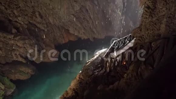 水滴滴在一个小山洞里的水里热带雨林景观中的瀑布视频的预览图