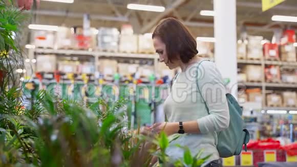 一个大超市里的女人选择盆栽花视频的预览图