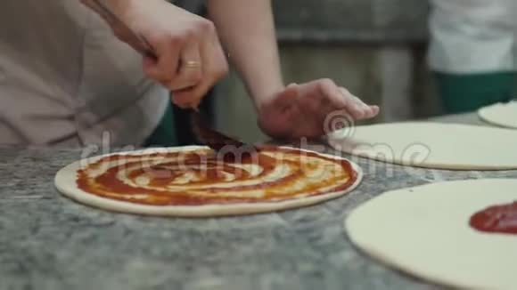 把番茄酱涂在披萨面团上视频的预览图