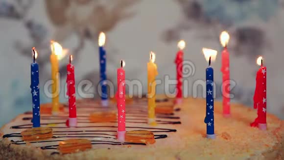 在五颜六色的生日蛋糕上吹蜡烛庆祝周年视频的预览图