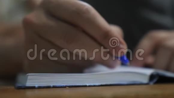 人在笔记本上写字男人手写在记事本上概念商业教育男人做生活笔记视频的预览图