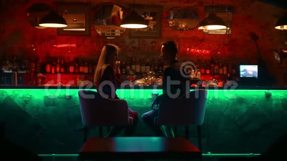 一对迷人的夫妇在酒吧里约会坐在旁边聊天视频的预览图