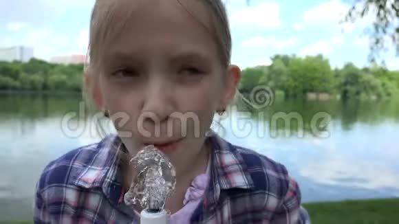 公园内的儿童饮用水喷泉室外4K的口渴女孩画像视频的预览图