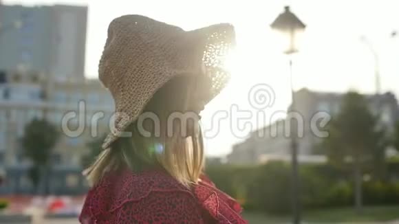 戴墨镜和帽子的年轻女人的肖像在炎热的夏天城市里的年轻女子慢动作视频的预览图