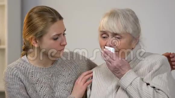 年轻的女士安慰不开心的哭泣奶奶痛苦的失去家庭的支持视频的预览图