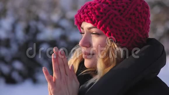 女人在寒冷的冬日暖手慢动作视频的预览图