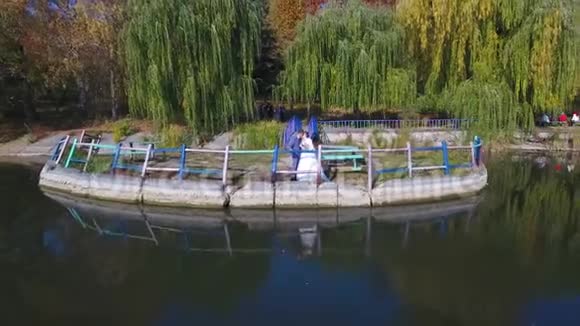 秋天在湖边的新婚夫妇视频的预览图