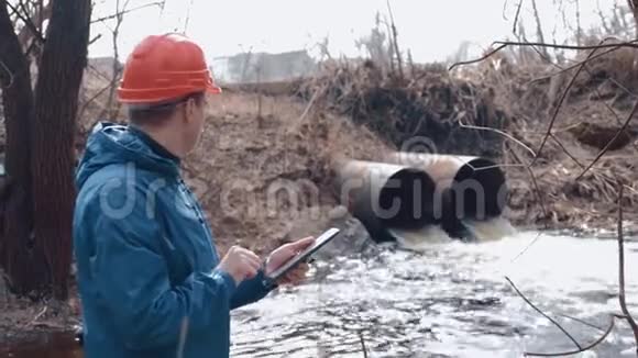 环境污染戴头盔戴口罩戴口罩的人可以测量废水的污染程度视频的预览图