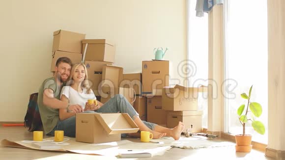 男人和女人在窗边喝茶购买新房子或公寓视频的预览图