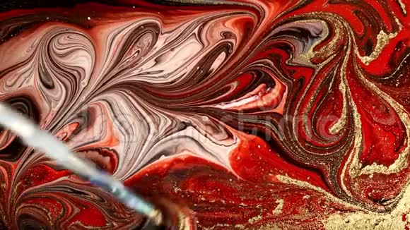 大理石迷幻运动红色和金色大理石图案的制作流体艺术大理石花纹背景视频的预览图