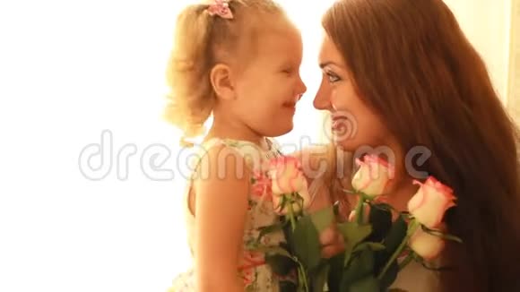 妈妈和女儿带着一束鲜花玫瑰母亲生日或生日的概念视频的预览图