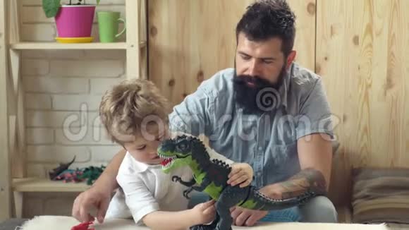 父子玩玩具恐龙父子之日快乐的父亲和儿子玩恐龙游戏视频的预览图