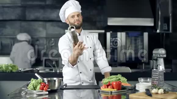 厨师在厨房餐厅摆姿势厨师在工作场所用胡椒盒热身视频的预览图