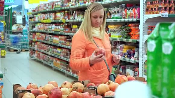 女子抱石榴果特写她选水果作为晚餐视频的预览图