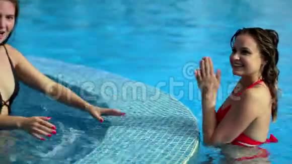 两个女朋友在游泳池里笑视频的预览图