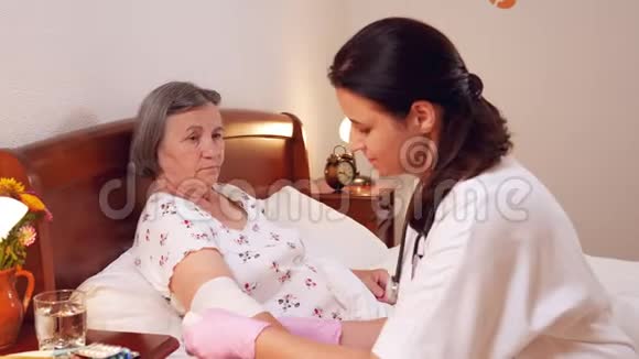 女医生在家中给老年妇女包扎胳膊肘视频的预览图