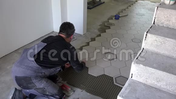 建筑工人在地板上放六边形瓷砖安装石材瓷砖视频的预览图