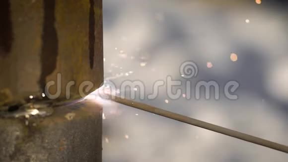 特写拍摄一名专业电焊工在室外焊接一根燃气管视频的预览图