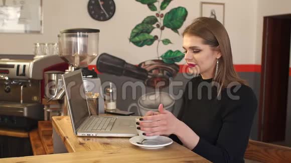 现代女商人在咖啡店用笔记本电脑工作视频的预览图