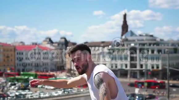 年轻迷人的时尚男士纹身自由式舞蹈在市中心的顶端指向视频的预览图
