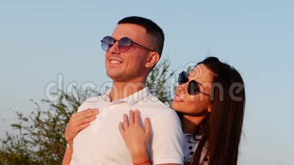 美丽幸福时尚欢乐年轻的欧洲可爱夫妇在黑色眼镜与美丽的微笑在彼此的手臂视频的预览图