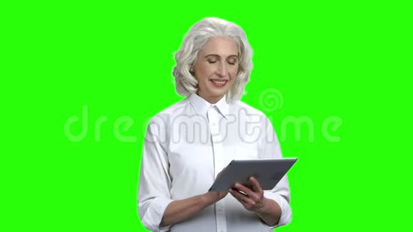 微笑高级妇女使用数字平板电脑视频的预览图