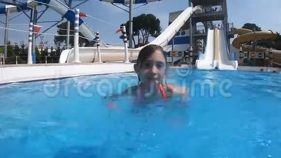 小女孩在水上公园的游泳池里游泳视频的预览图