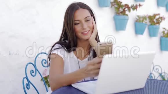 内容女孩在外面用笔记本电脑放松视频的预览图