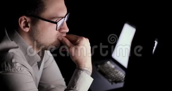 人在电脑工作思考和分析监控屏幕上的指标视频的预览图