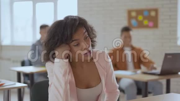 疲倦困倦的女人在讲座上睡着了一个长相异国的女孩正在打哈欠慢慢地眨眼学生群体视频的预览图