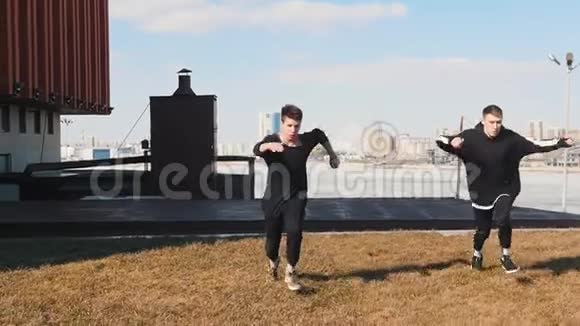 两个人在草地上奔跑表演翻转动作视频的预览图