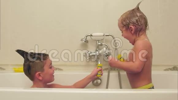 两个小男孩在浴缸洗澡时玩得很开心视频的预览图