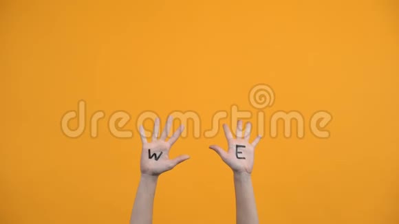 我们在橙色的背景上写下手掌志愿者举手团聚视频的预览图