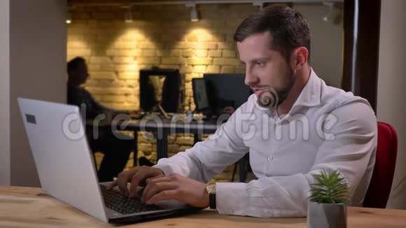 快乐的成年白人商人在笔记本电脑上工作并因成功而兴奋的特写照片视频的预览图