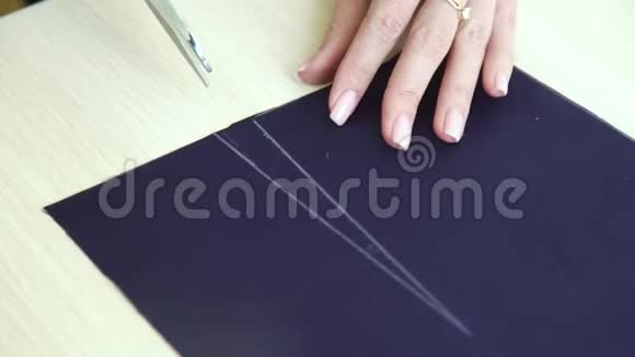 年轻女子用剪刀剪布的美手特写视频的预览图