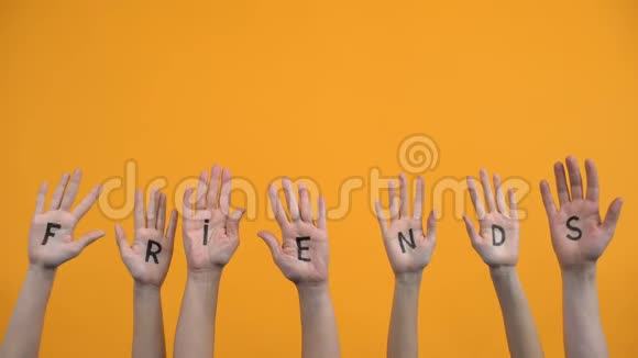 朋友用手掌写在橙色背景上团结联系帮助视频的预览图