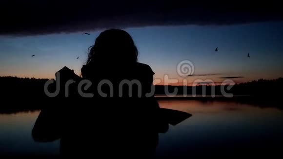 一个女孩在湖中划独木舟鸟儿在飞翔美丽的风景和全景视频的预览图