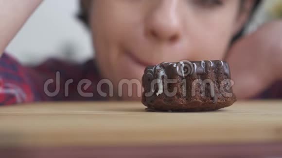 小美味的巧克力蛋糕有美味的糖霜在一个饥饿的美丽女孩的背景关门视频的预览图