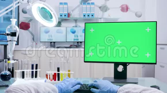 用绿色屏幕模型在电脑键盘上键入白色封面的化学家照片视频的预览图