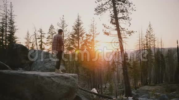 在约塞米蒂公园慢动作拍摄史诗般的日落照片这是一位年轻的男性记者欣赏野生森林的不可思议的镜头视频的预览图