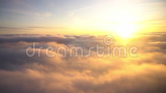 从飞机上俯瞰天空日出和云录像金色的太阳和柔和的白云在蓝色的天空中闪耀视频的预览图