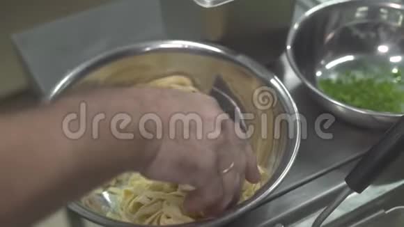 在餐厅厨房用开水煮生意面厨师把新鲜面食放入热煮的手视频的预览图