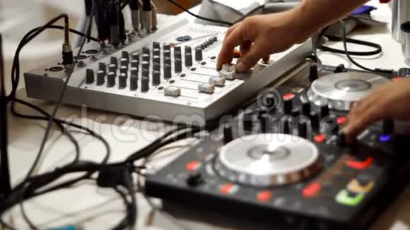 中间部分结束DJ在时尚俱乐部播放音乐库存录像关闭一个人在DJ控制台上玩视频的预览图