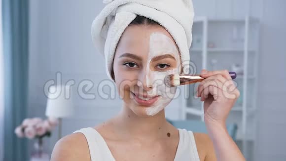 英俊的女人在脸上敷面膜的肖像视频的预览图